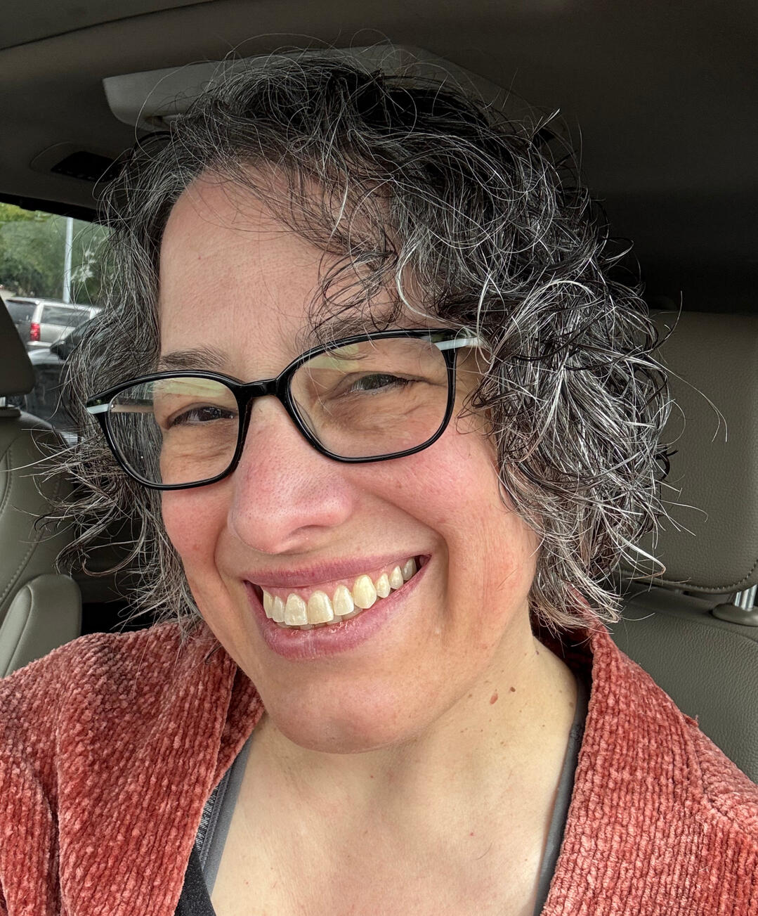 Photo of the author wearing glasses and smiling.